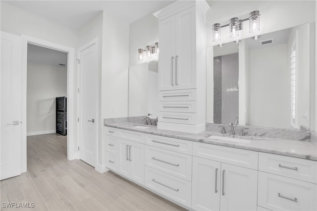 bathroom with vanity and hardwood / wood-style floors