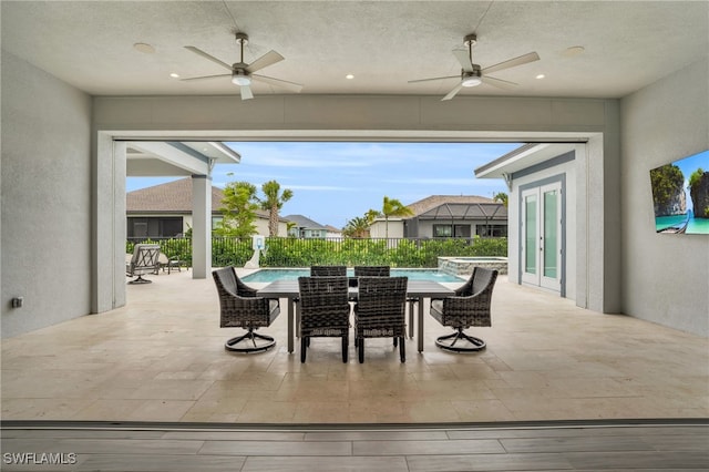 view of patio featuring ceiling fan, a lanai, and a fenced in pool