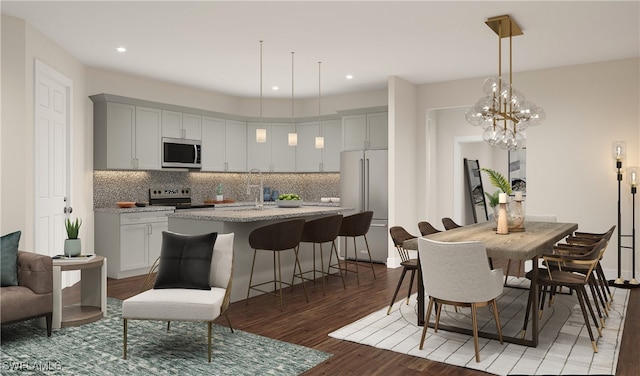 kitchen featuring a kitchen island with sink, dark hardwood / wood-style floors, stainless steel appliances, light stone countertops, and tasteful backsplash