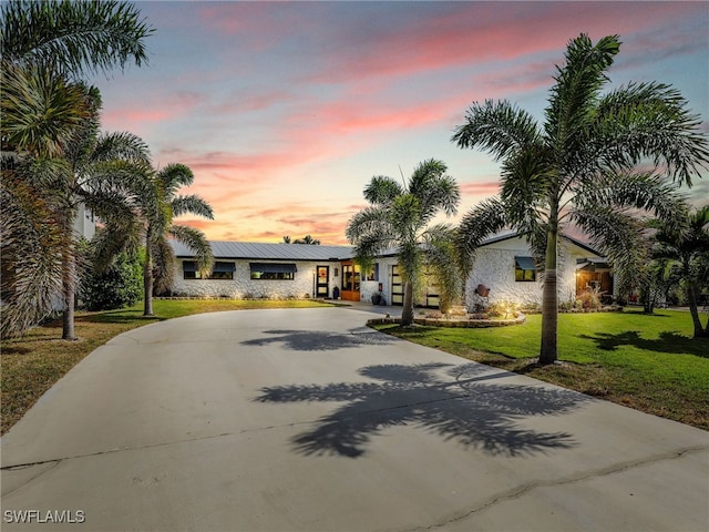 view of front of house with a yard