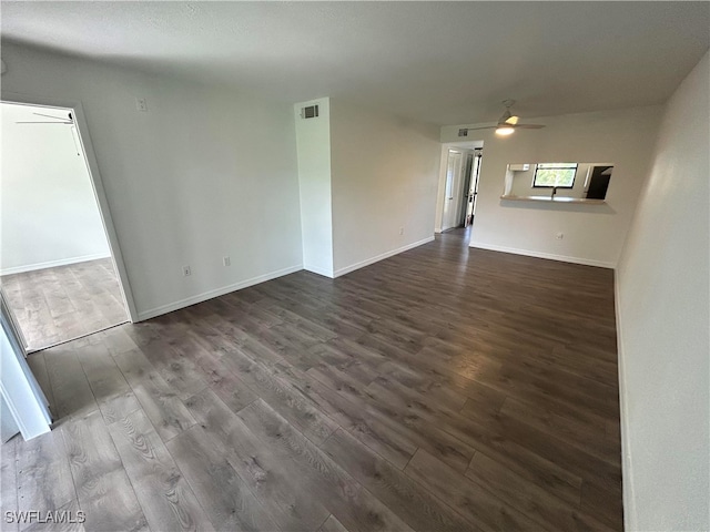 unfurnished living room with ceiling fan and dark hardwood / wood-style floors