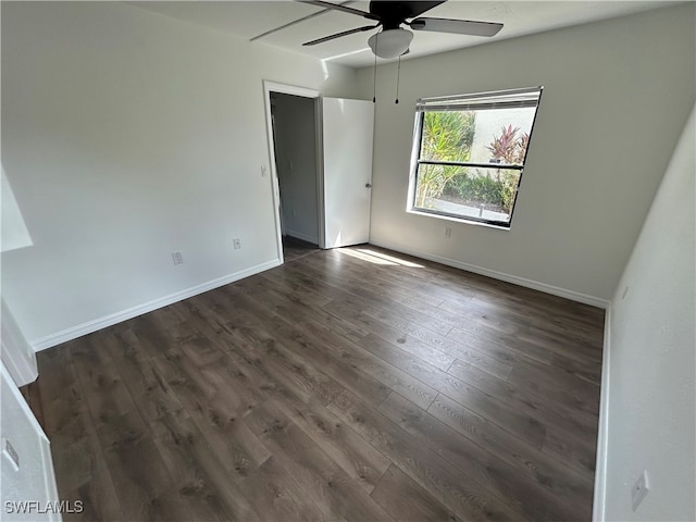 empty room with dark hardwood / wood-style floors and ceiling fan