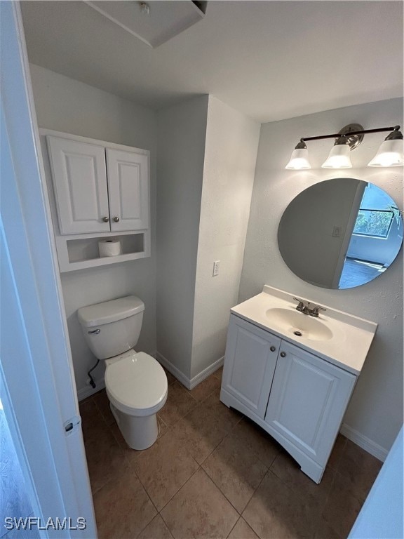 bathroom with vanity, toilet, and tile patterned floors