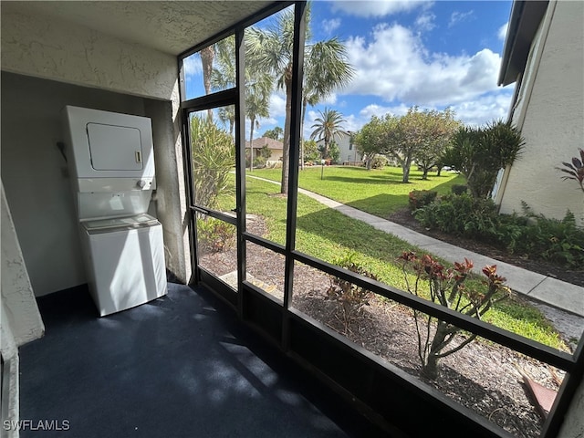 unfurnished sunroom with stacked washer and dryer