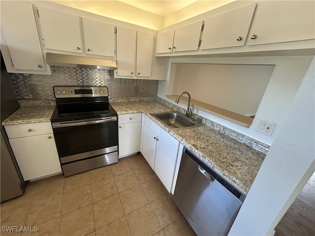 kitchen featuring sink, white cabinets, stainless steel appliances, and backsplash