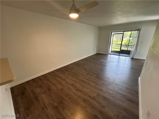 spare room featuring dark hardwood / wood-style floors and ceiling fan