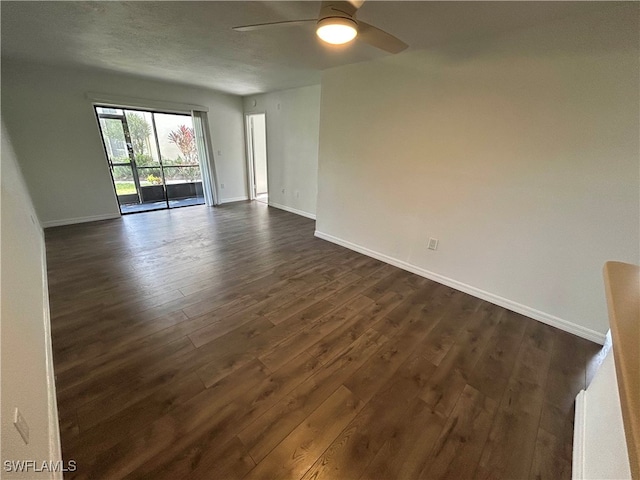 unfurnished room featuring ceiling fan and dark hardwood / wood-style flooring