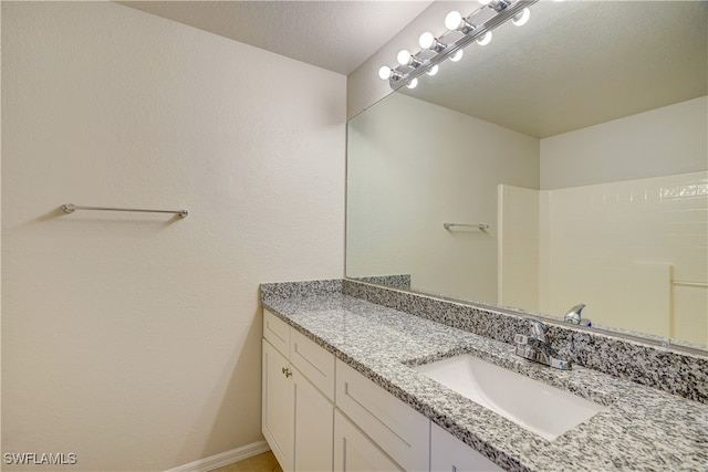 bathroom featuring vanity and a textured ceiling