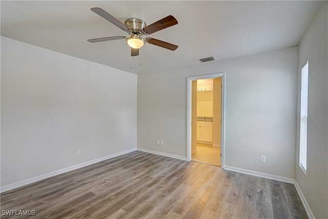 unfurnished room with light hardwood / wood-style flooring and ceiling fan