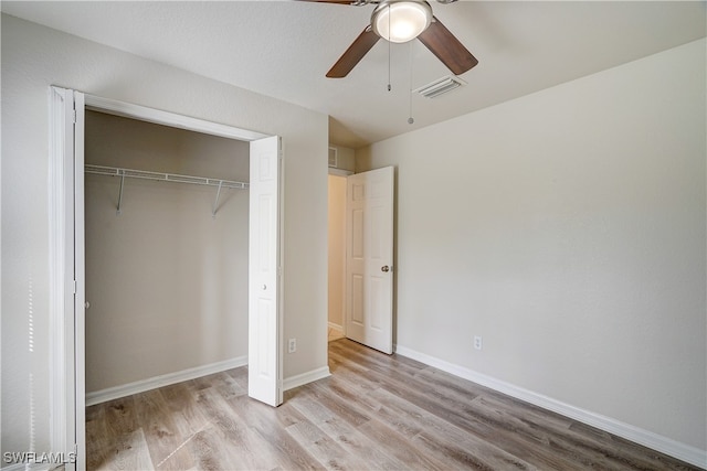 unfurnished bedroom with a closet, ceiling fan, and light hardwood / wood-style flooring