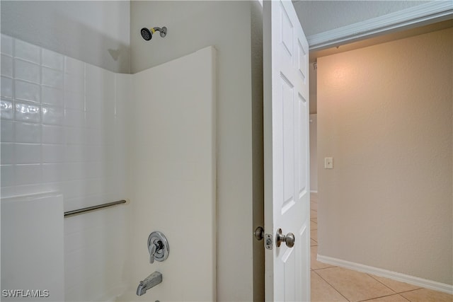 bathroom featuring tile patterned flooring and  shower combination