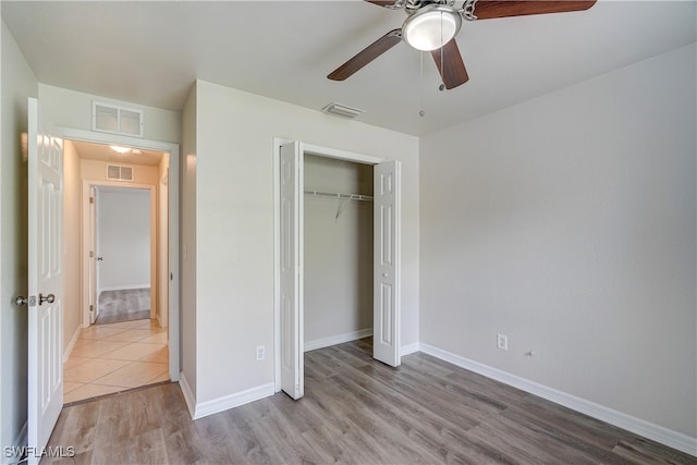 unfurnished bedroom with a closet, ceiling fan, and light hardwood / wood-style flooring