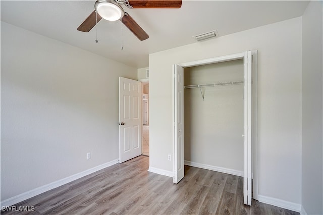 unfurnished bedroom with a closet, ceiling fan, and light hardwood / wood-style floors