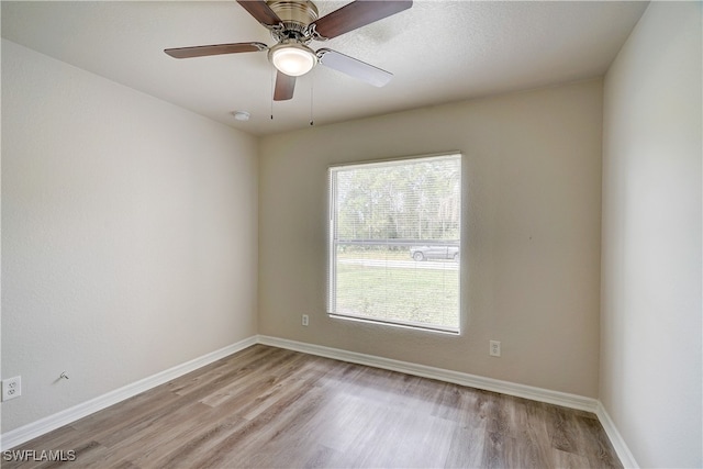 empty room with light wood-type flooring and ceiling fan