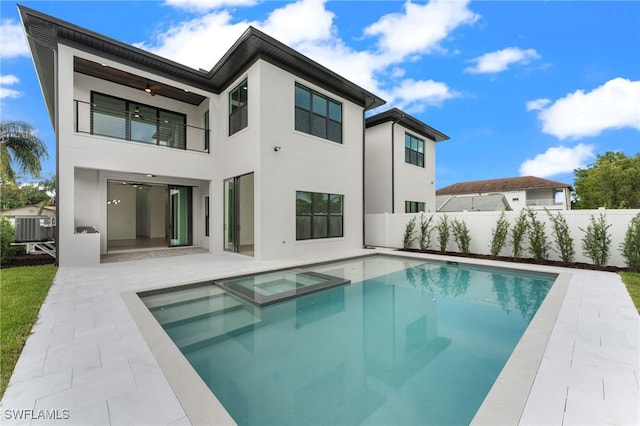 back of house featuring a patio, central AC unit, ceiling fan, and a pool with hot tub