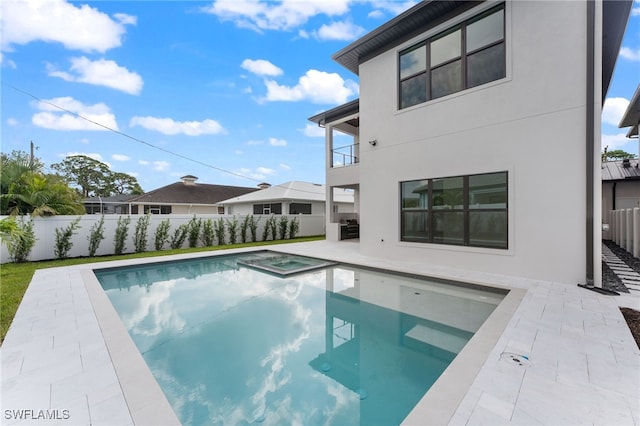 view of swimming pool with a patio area and an in ground hot tub