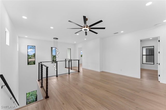 spare room featuring ceiling fan and light hardwood / wood-style flooring