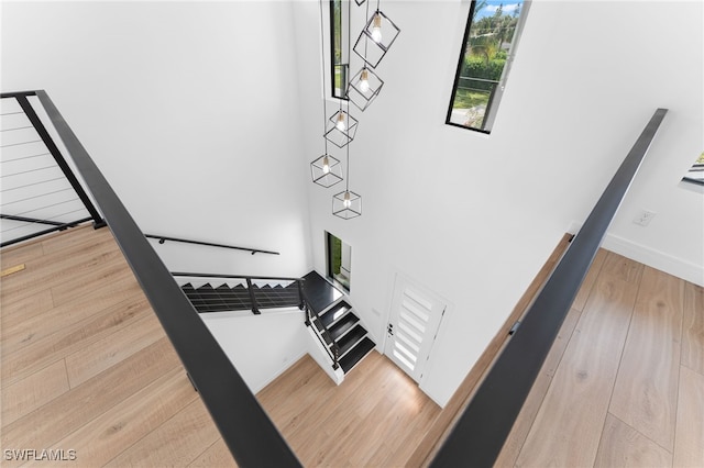 staircase with hardwood / wood-style floors