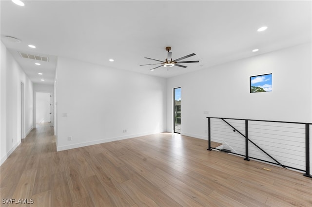 unfurnished room featuring light wood-type flooring and ceiling fan