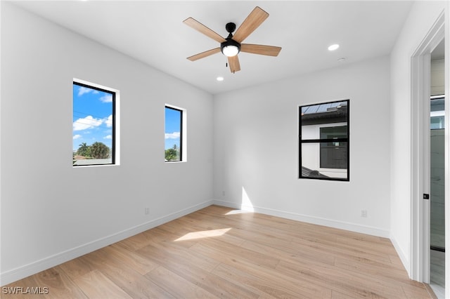 empty room with ceiling fan and light wood-type flooring