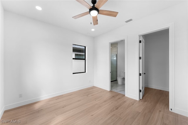 unfurnished bedroom with ensuite bath, ceiling fan, and light hardwood / wood-style flooring