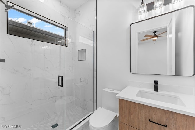 bathroom featuring ceiling fan, toilet, an enclosed shower, and vanity