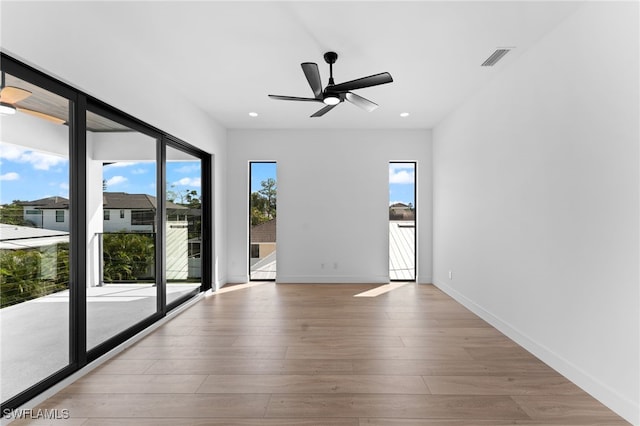 spare room with light hardwood / wood-style flooring and ceiling fan