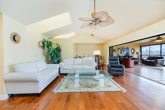 living room featuring wood-type flooring, vaulted ceiling, and ceiling fan