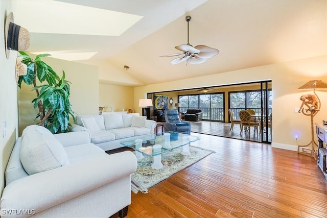 living room featuring hardwood / wood-style floors, ceiling fan, and lofted ceiling