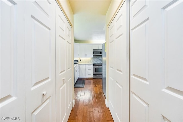 corridor featuring dark hardwood / wood-style flooring