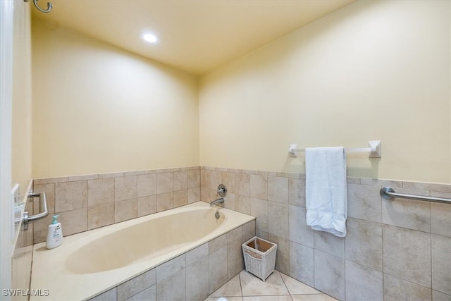 bathroom featuring tile patterned floors and tiled bath