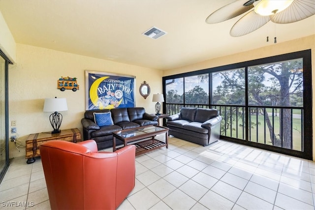 tiled living room with ceiling fan