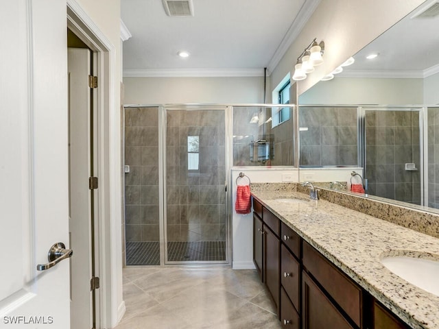 bathroom featuring vanity, crown molding, tile patterned flooring, and a shower with door