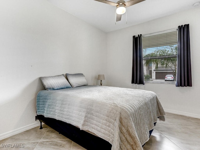 tiled bedroom featuring ceiling fan