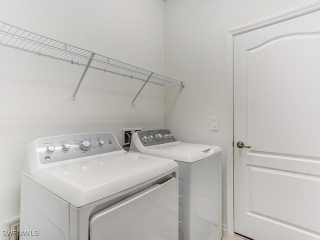 laundry area with washing machine and dryer