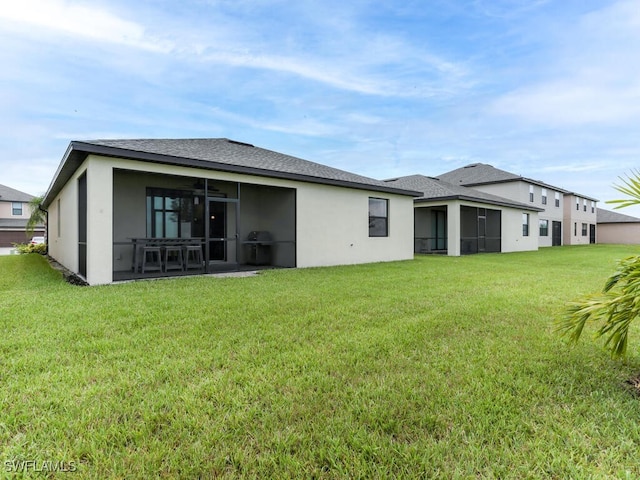 back of house with a patio and a lawn