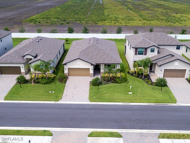 view of front facade featuring a front yard and a garage