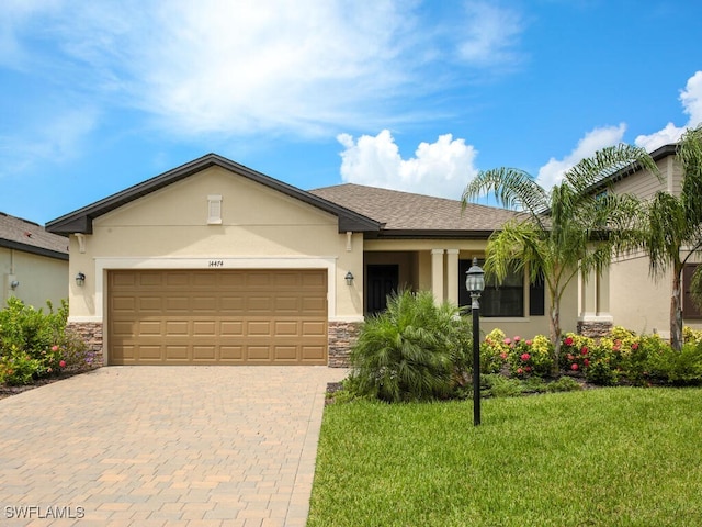 single story home featuring a front lawn and a garage