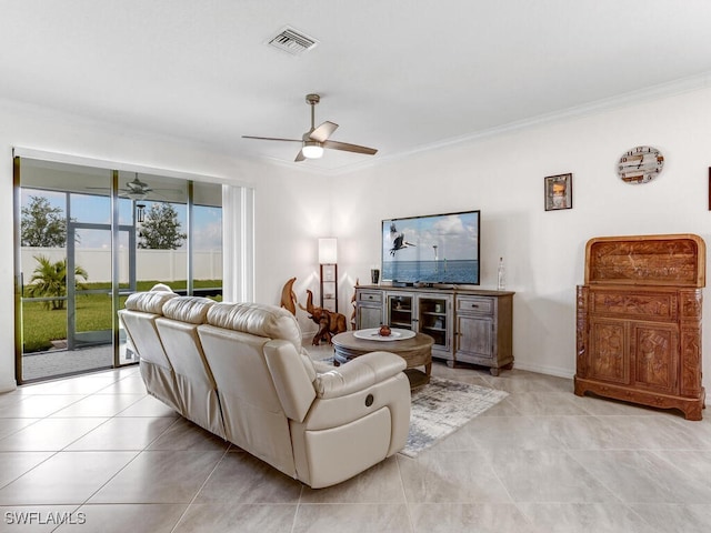 living room with crown molding, light tile patterned floors, and ceiling fan