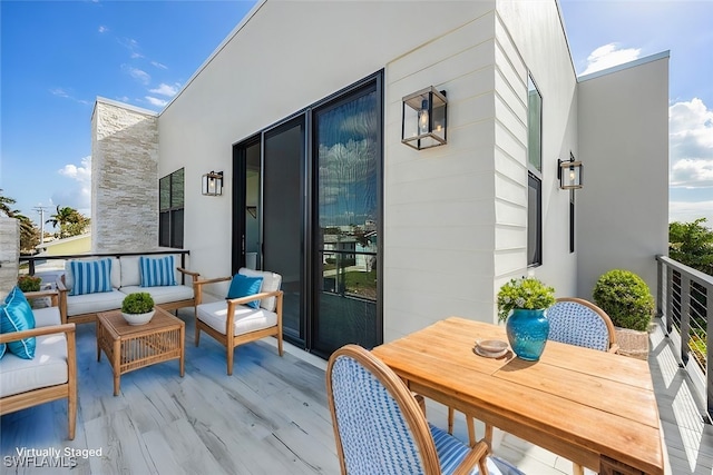 balcony featuring outdoor dining area and an outdoor living space