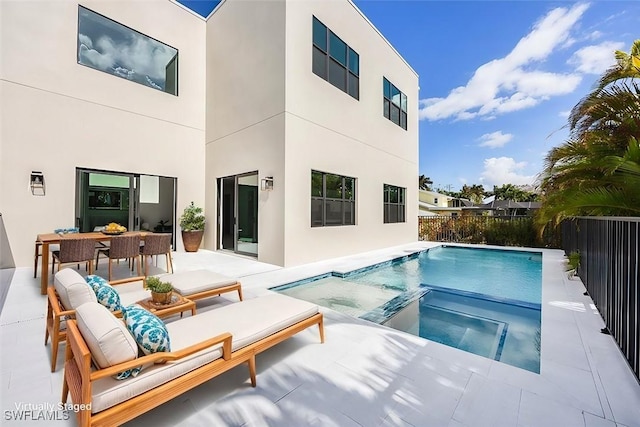 view of pool featuring fence, outdoor dining area, a patio, and an in ground hot tub