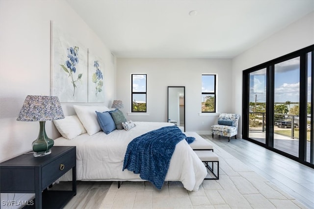 bedroom with light hardwood / wood-style flooring and access to outside