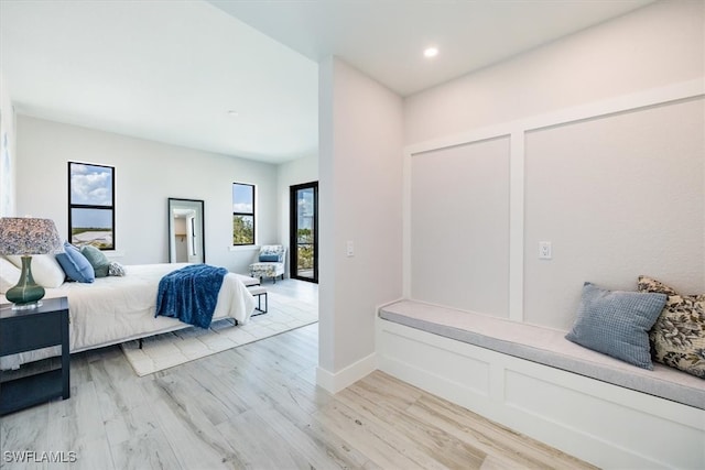 bedroom with baseboards, recessed lighting, and light wood-style floors