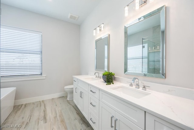 full bathroom with toilet, independent shower and bath, hardwood / wood-style floors, and vanity