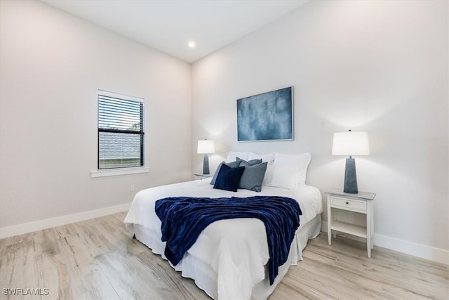 bedroom featuring light wood-type flooring, baseboards, and recessed lighting