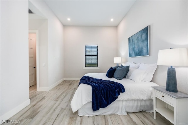 bedroom with baseboards, recessed lighting, visible vents, and light wood-style floors