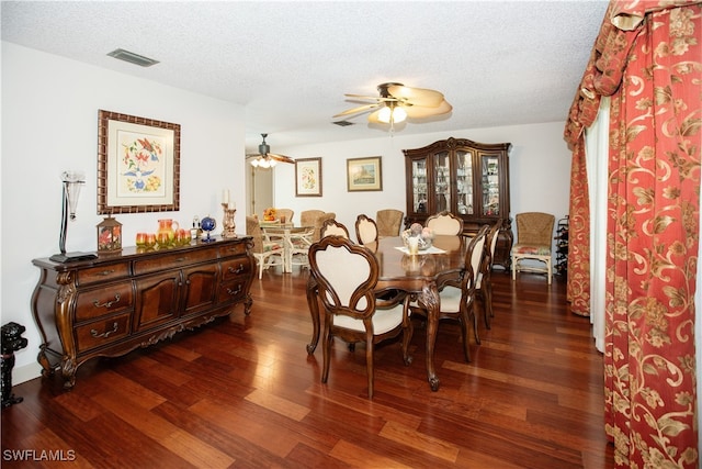 dining room featuring ceiling fan, a textured ceiling, and dark hardwood / wood-style flooring