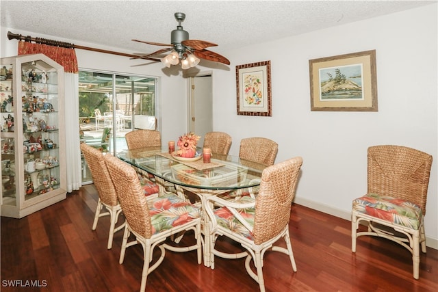 dining room with dark wood-type flooring, a textured ceiling, and ceiling fan