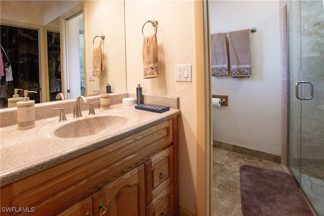 bathroom featuring vanity and an enclosed shower