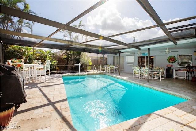 207 SE 20th Pl, Cape Coral, FL 33990 - swimming pool featuring outdoor dining area, a patio, glass enclosure, and a ceiling fan